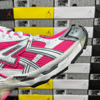 Lace-up running sneaker with white and hot pink upper and gray outsole tread