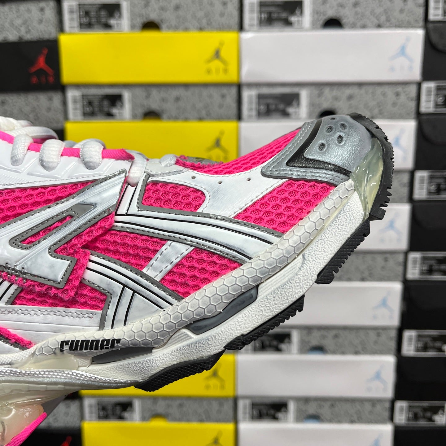 Lace-up running sneaker with white and hot pink upper and gray outsole tread