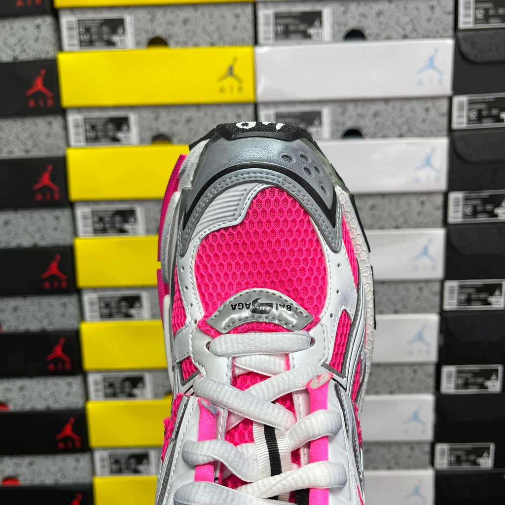 Lace-up running sneaker with white uppers, hot pink accents, and gray heel panel