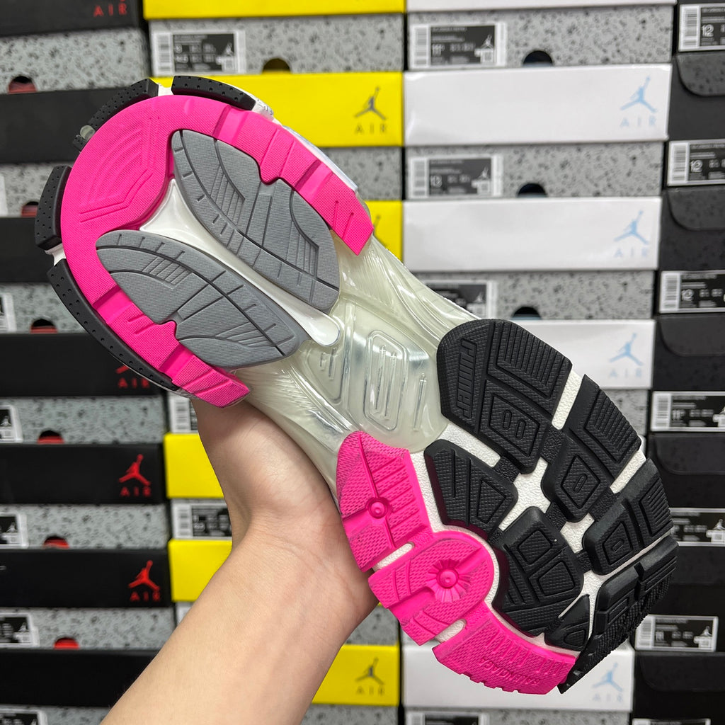 Running sneaker outsole with pink tread, gray traction blocks, and black side insert