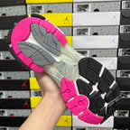 Running sneaker outsole with pink tread, gray traction blocks, and black side insert