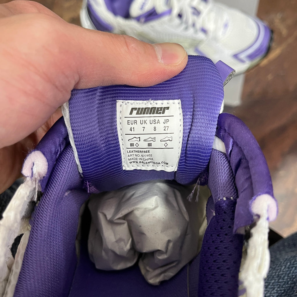 Fabric size label inside purple collar of white and purple lace-up sneaker.