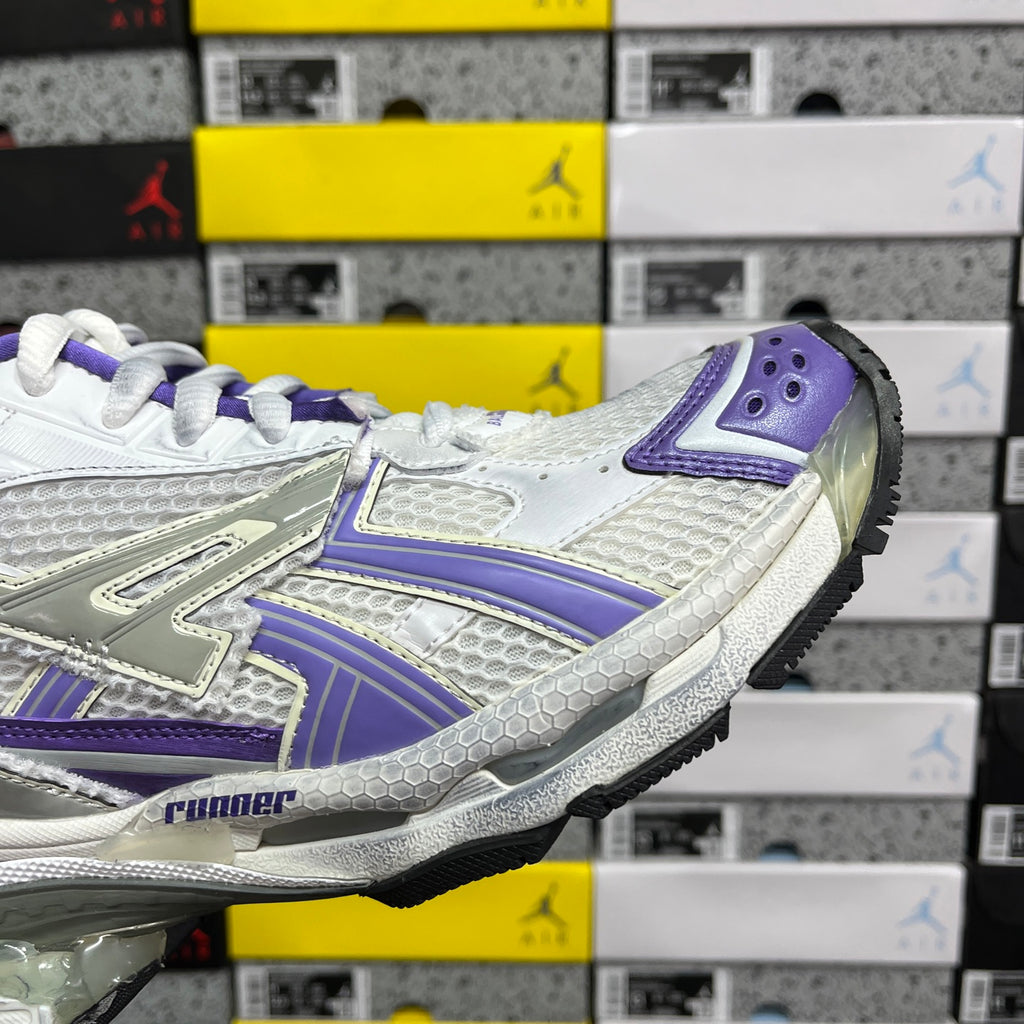 White and purple lace-up sneaker with bold side panel stripes.