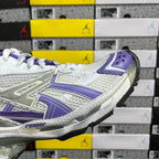 White and purple lace-up sneaker with bold side panel stripes.