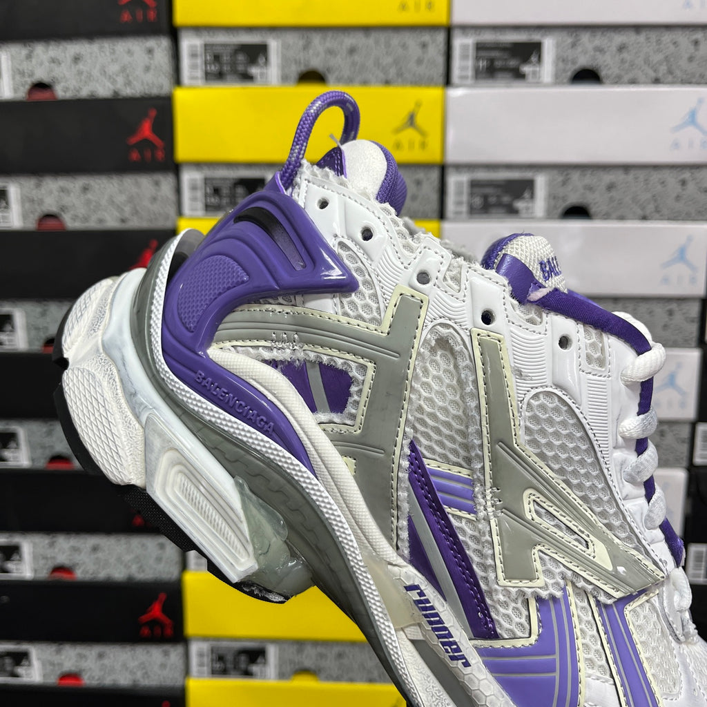 White and purple lace-up sneaker with purple heel and layered cushioning.
