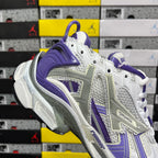 White and purple lace-up sneaker with purple heel and layered cushioning.
