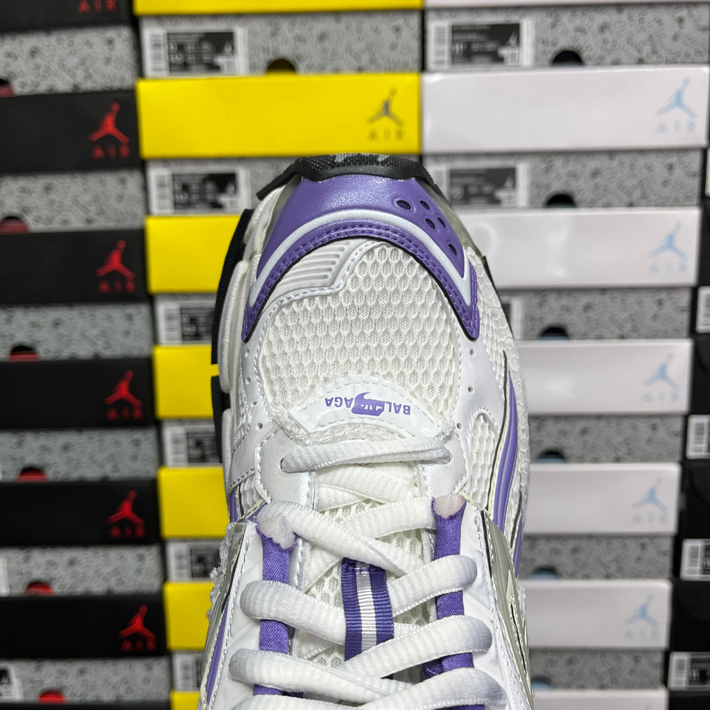 Purple and white sneaker heel with BALENCIAGA logo on back strap.