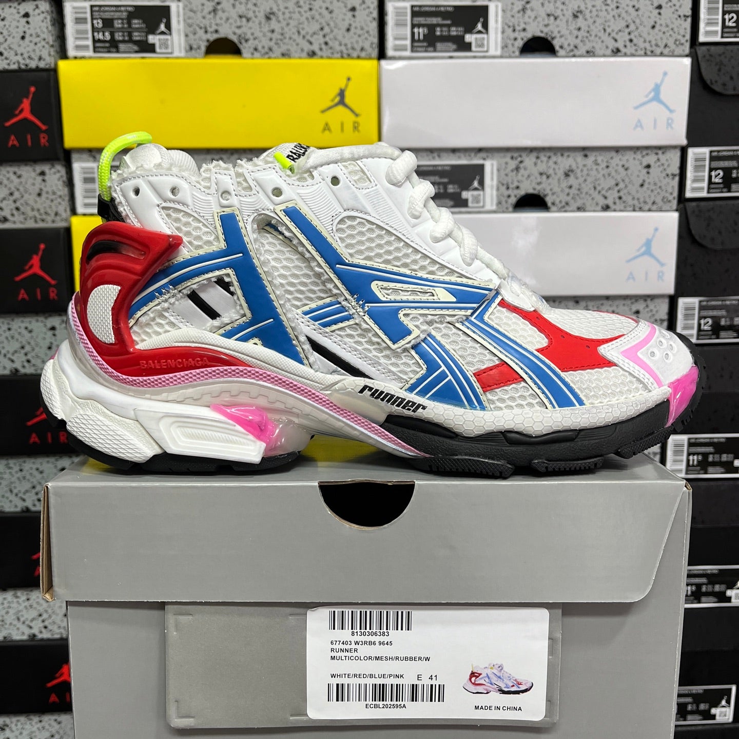Unisex sneaker showing white, blue, red color blocking with neon green heel and laces