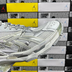 Light silver/white lace-up sneaker with metallic side panels and chunky outsole