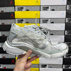 Light silver/white lace-up sneaker front view with textured toe and laces