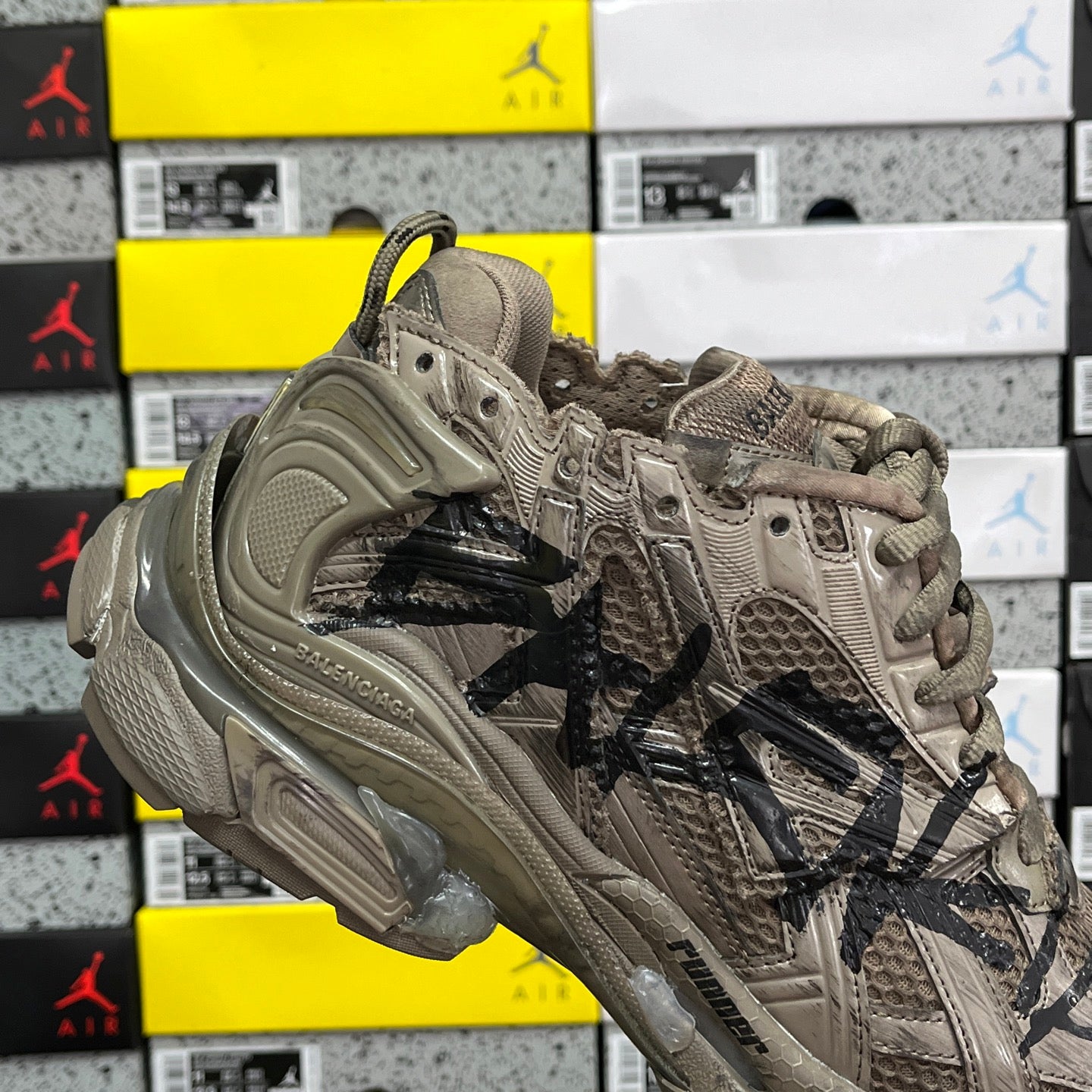 Balenciaga unisex sneakers quarter view in taupe with black logo stripe and laces