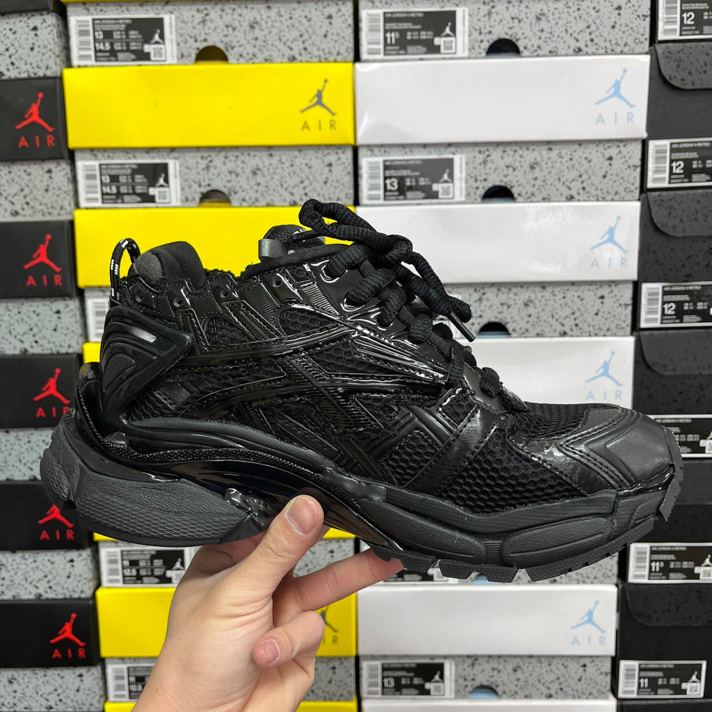 Black Balenciaga running sneaker, three-quarter side view with chunky midsole