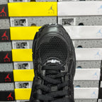 Black Balenciaga running sneaker heel view with mesh panel and black laces