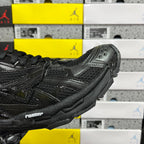Black Balenciaga running sneaker, close side detail with glossy overlays and laces