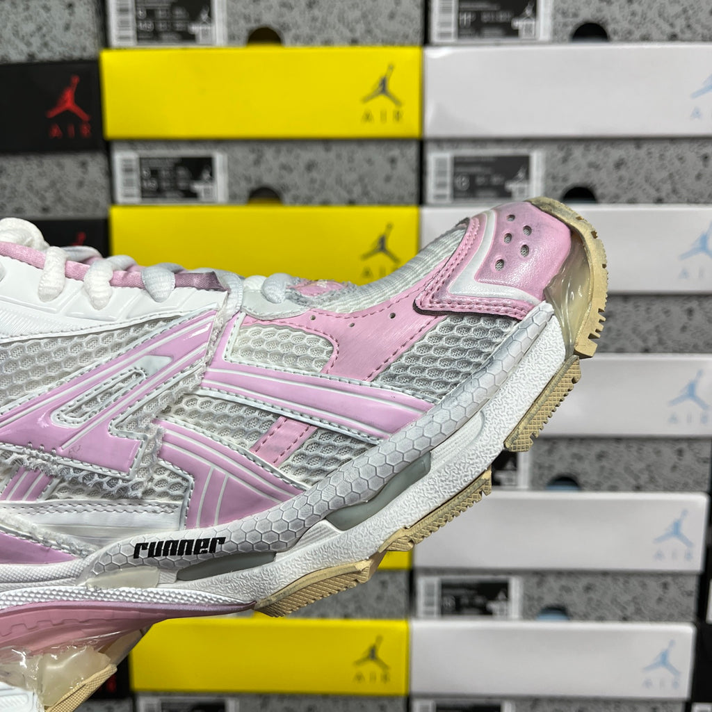 White and pink sneaker side view with striped overlays and thick sole