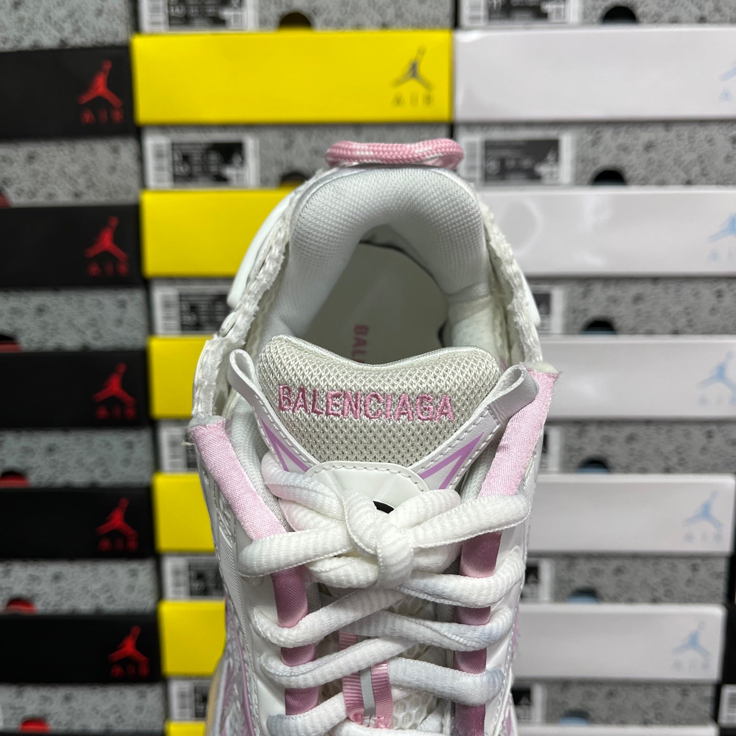 White sneaker heel with pink trim, lace-up closure, and Balenciaga logo label