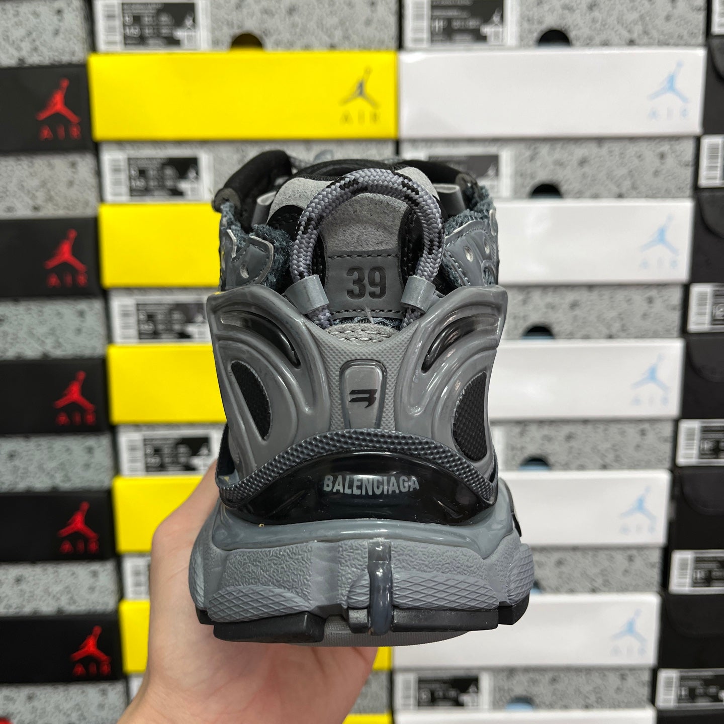 Grey lace-up runner sneaker heel with size tag marked 39.