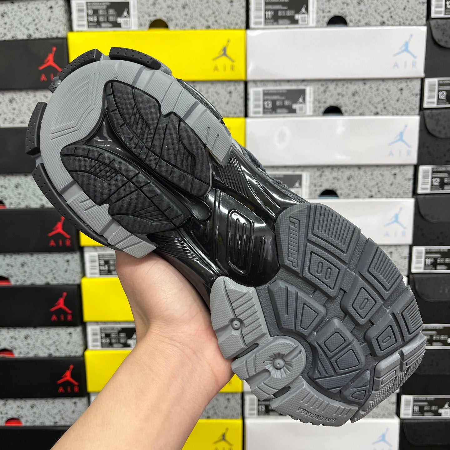 Grey rubber outsole tread for runner sneakers, visible pivot and traction pattern.