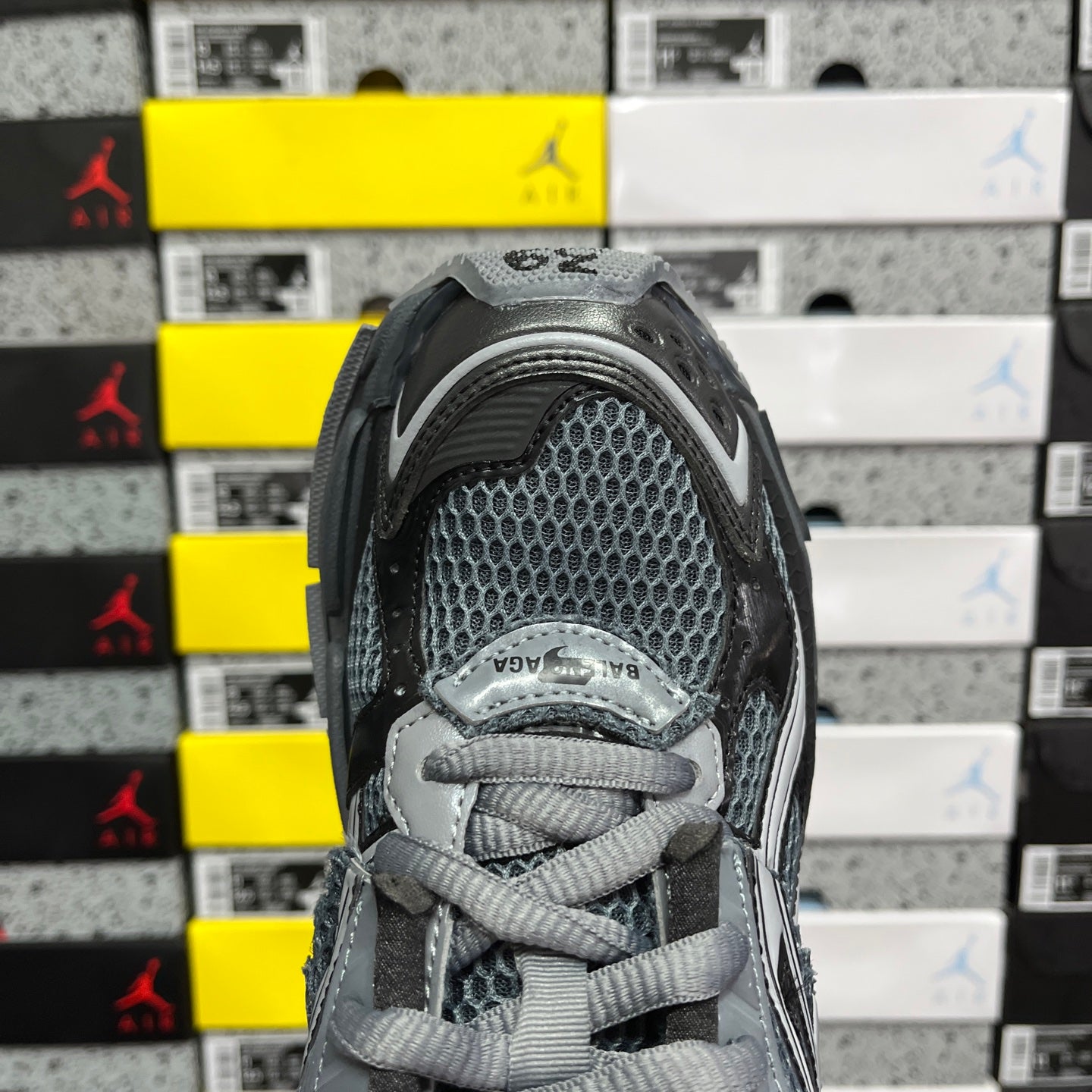 Balenciaga grey mesh lace-up sneaker close-up with tongue and padded collar.