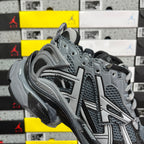 Grey lace-up runner sneaker with sculpted midsole and mesh panels.