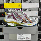 Silver athletic sneaker with purple accents, orange stripe, and multicolor midsole