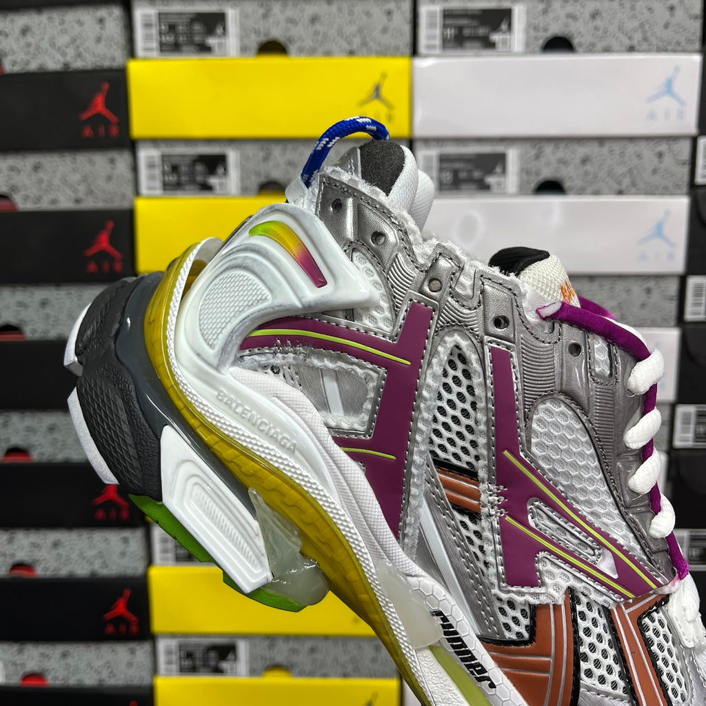 Silver sneaker heel with purple accents, brown stripe, yellow-green midsole, white laces