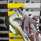 Silver sneaker heel with purple accents, brown stripe, yellow-green midsole, white laces