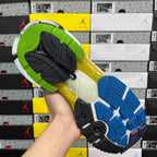 Multicolor sneaker outsole with green, yellow, and blue tread pattern