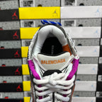 Silver sneaker heel with Balenciaga logo, purple collar lining, and white laces