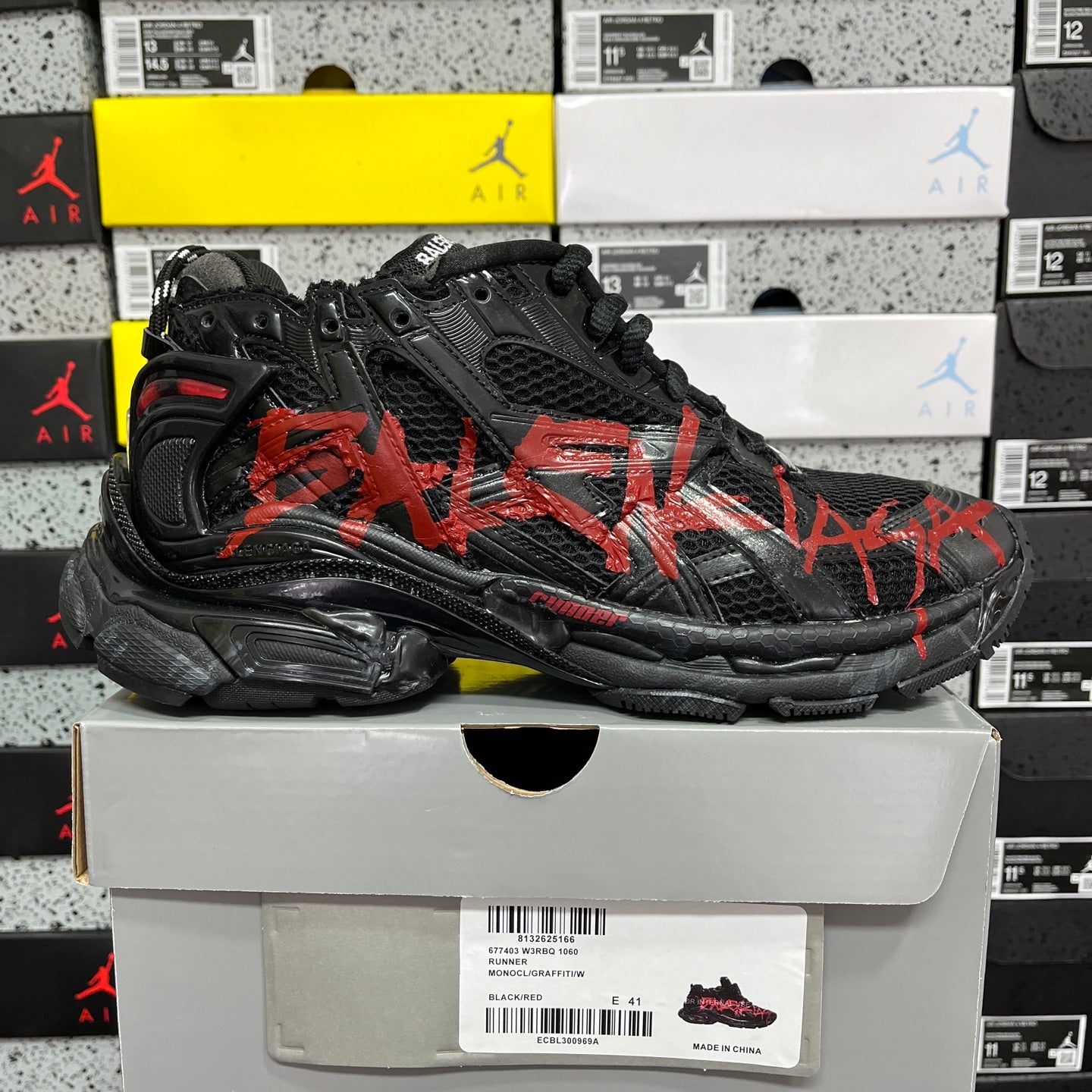 Black and red Balenciaga runner sneaker, side view with thick rubber sole