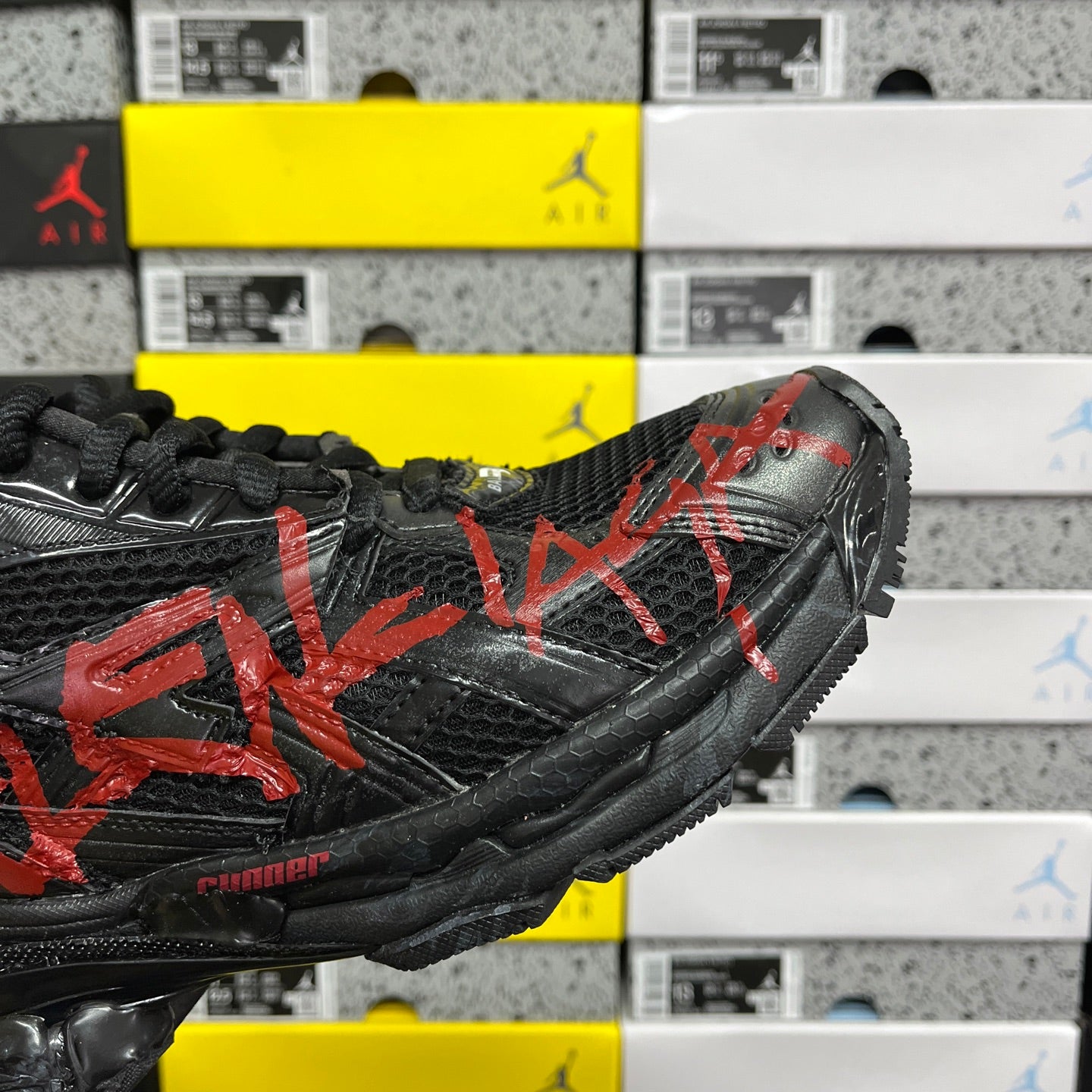 Black and red Balenciaga runner sneaker, angled side profile