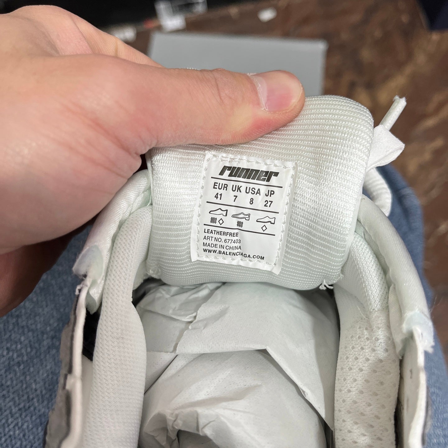 White sneaker tongue with size label and inner lining details