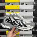 Silver and black high-top sneakers with white laces and chunky tread sole