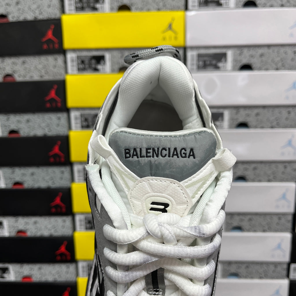 White high-top sneakers with BALENCIAGA logo on the heel collar and white laces