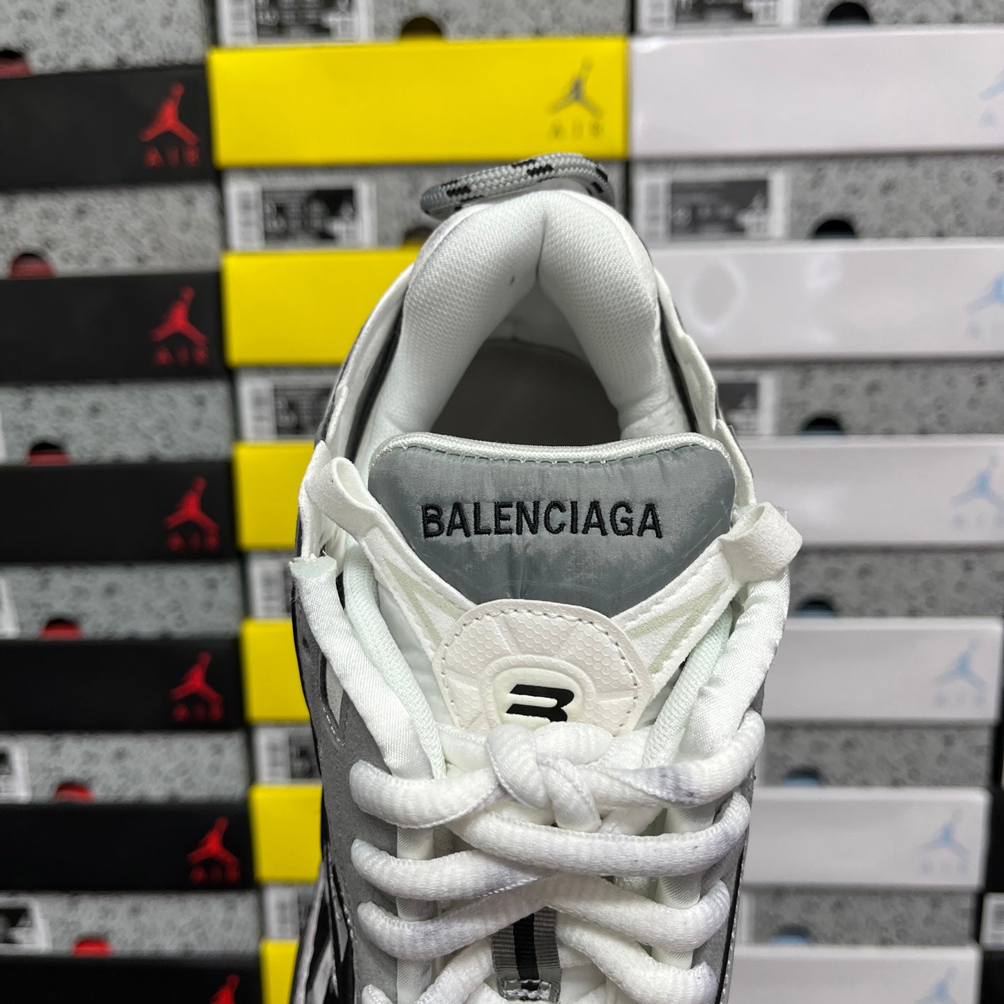 White high-top sneakers with BALENCIAGA logo on the heel collar and white laces
