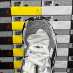 Gray and white high-top sneakers with white laces and perforated toe panel