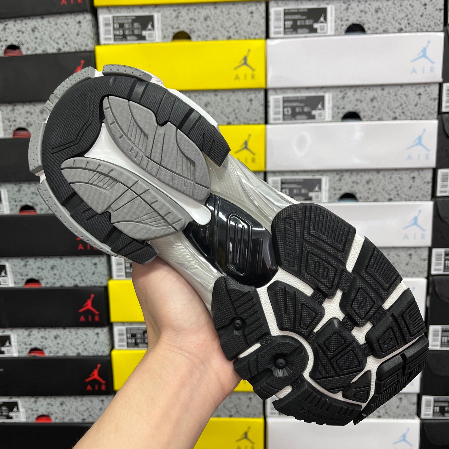 Shoe outsole with black traction pads and gray tread pattern