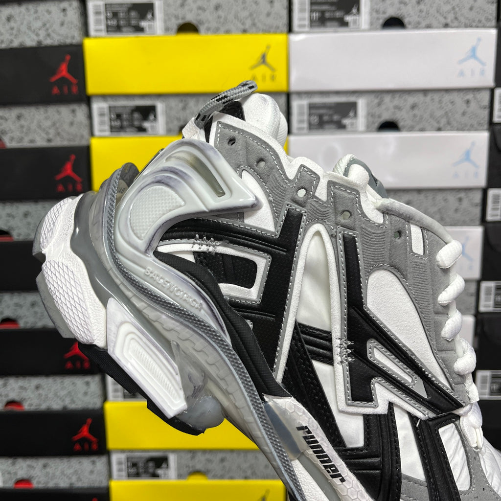 Silver and black high-top sneakers with white laces and bulky shock-absorbing sole