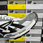 Silver, gray, and black high-top sneakers with white laces and side stripes