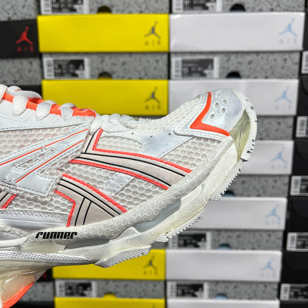 Balenciaga runner sneakers side detail, white upper with orange trim and runner logo