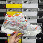 Balenciaga runner sneakers 3/4 view, white mesh with orange stripes and thick sole
