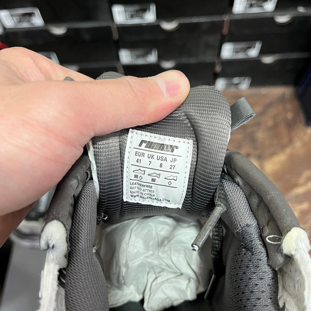 Gray sneaker tongue label showing size and brand details, with BALENCIAGA web address