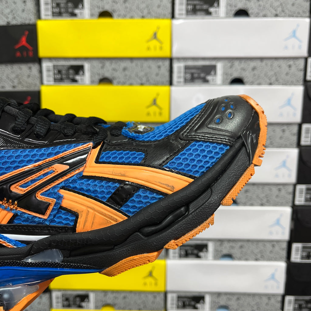 High-top unisex sneakers side view: blue-and-orange graphics on black upper