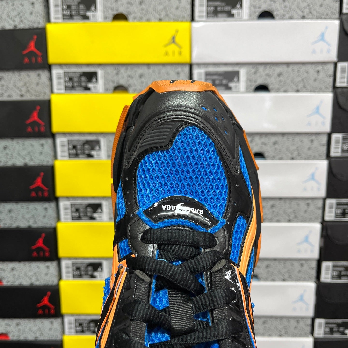 High-top unisex sneakers, blue mesh toe with black laces and orange edging