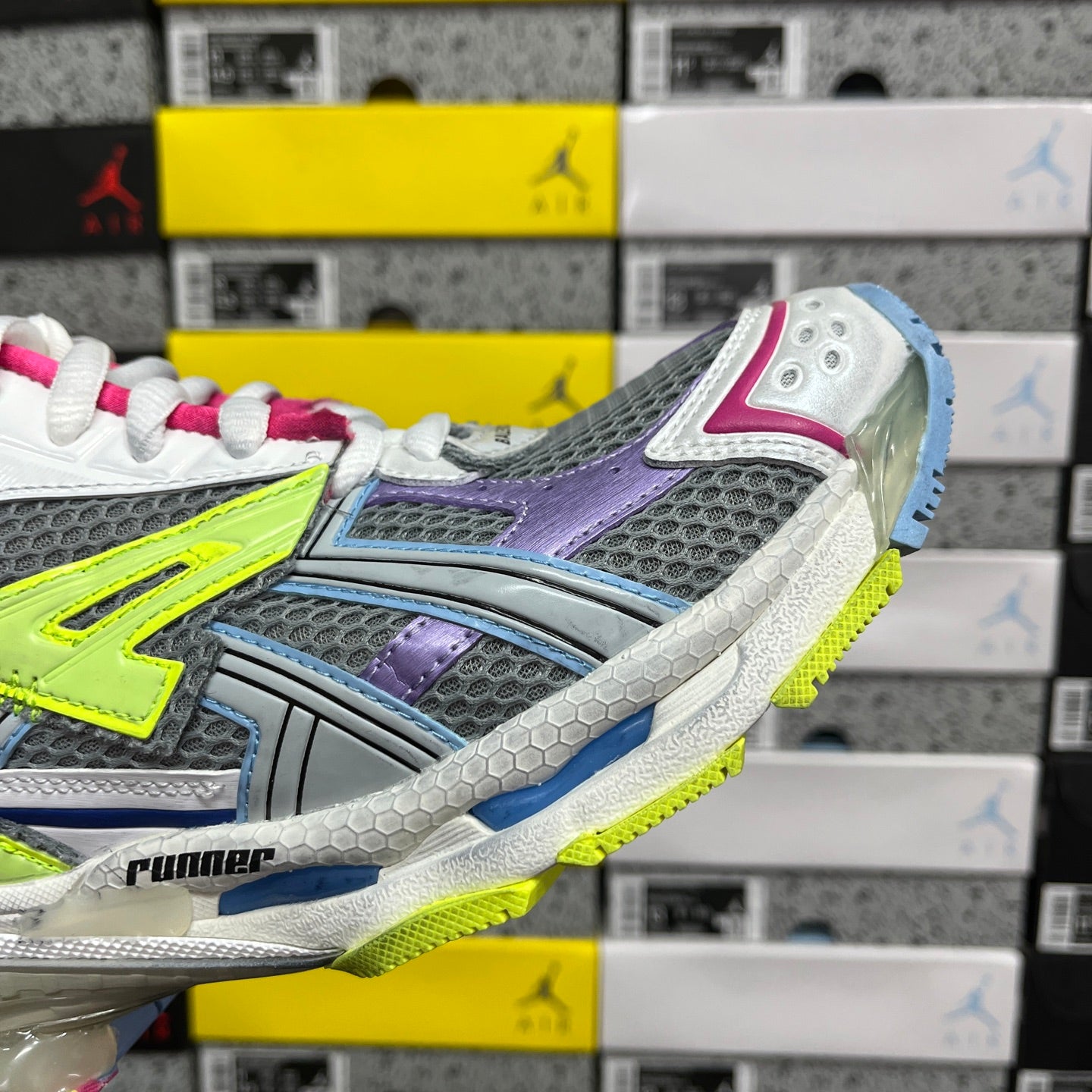 Balenciaga unisex sneaker side view, multicolor panels with neon green and purple accents