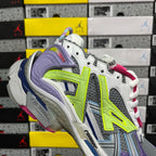 Balenciaga unisex sneaker side view, white upper with neon green logo panels and pink laces