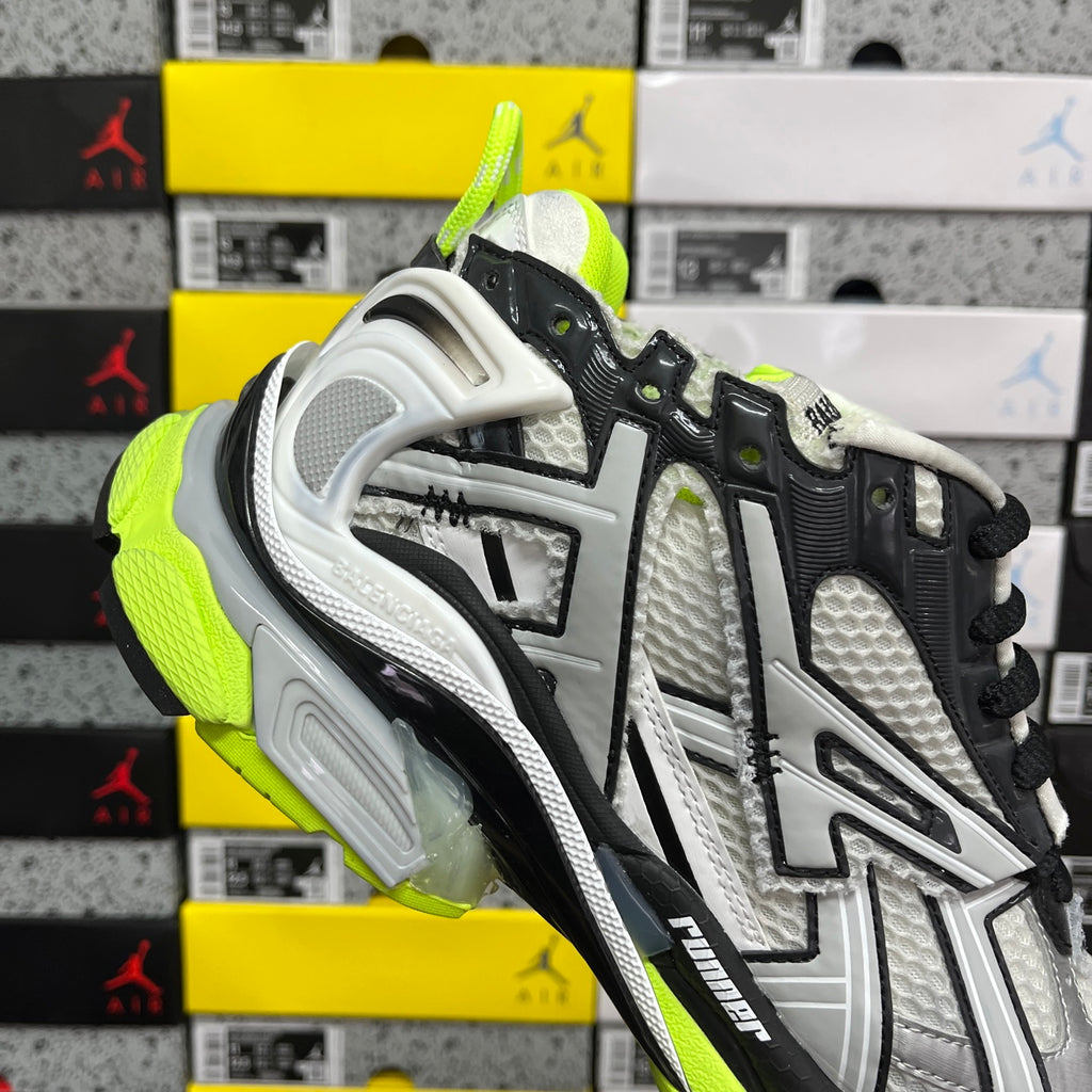 Balenciaga unisex sneakers side view, black overlays on silver mesh with neon green trim