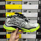 Balenciaga unisex sneakers front view, silver and black upper with neon green midsole