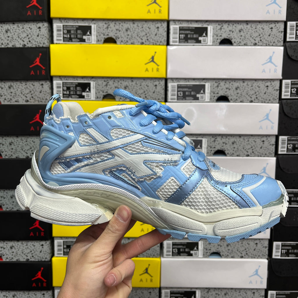 Blue and white lace-up athletic sneaker, front side view with padded collar