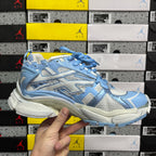 Blue and white lace-up athletic sneaker, front side view with padded collar